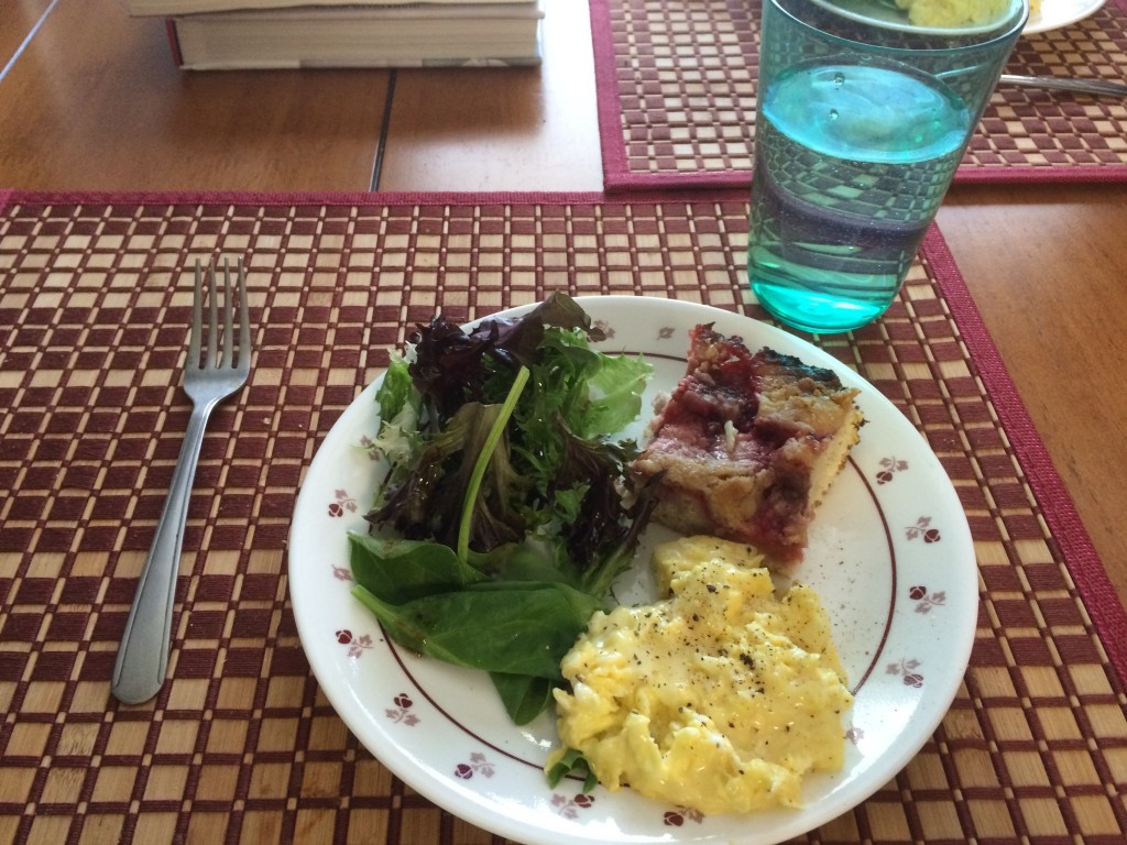 Cheesy scrambled eggs, salad greens, leftover long-cake